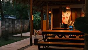 a table and benches in front of a restaurant at Ostello in Varkala