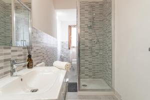 a white bathroom with a sink and a shower at Urban Center Arezzo in Arezzo +31 photos