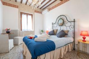 a bedroom with a large bed with blue sheets and pillows at Urban Center Arezzo in Arezzo