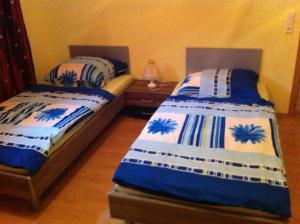 dos camas sentadas una al lado de la otra en un dormitorio en Appartements Funk, en Pfungstadt