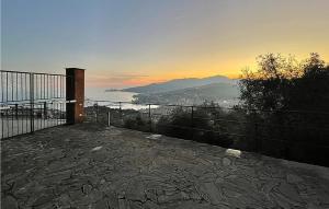a balcony with a view of the ocean at sunset at 3 Bedroom Beautiful Home In Rapallo in Rapallo +39 photos