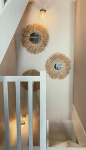 a staircase with three circular mirrors on the wall at Charmante maison de ville 2 chambres avec terrasse, très calme in Marseillan