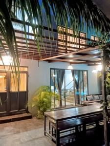 a dining room with a wooden table and a bench at Akira villa in Port Louis