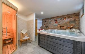 a large bath tub in a bathroom with a brick wall at Lovely Home In Lestakovec With Kitchen in Leštakovec +32 photos