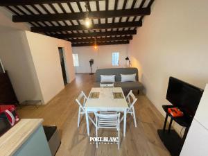 a living room with a table and a couch at PortBlanc Apartments - 4 in Arenys de Mar