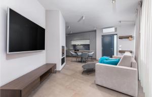 a living room with a couch and a flat screen tv at Nice Home In Labin With Wifi in Labin