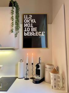 a kitchen counter with two candles on a counter top at APARTMENT KLAGENFURT Villa Frank No2 - with Free Parking, Smart-TV & Self Check-in in Klagenfurt +26 photos
