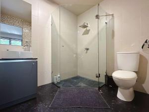 a bathroom with a toilet and a sink and a shower at Apartment On Star Unit 1 in Sandy Bay +8 photos