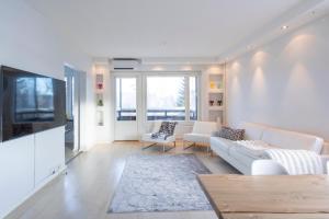 a living room with a couch and a tv at ArcticFox Apartment in Rovaniemi