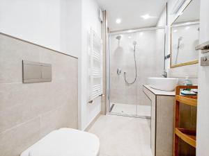 a bathroom with a shower and a toilet and a sink at Lakeside Apartment By Iulius Mall in Cluj-Napoca +28 photos