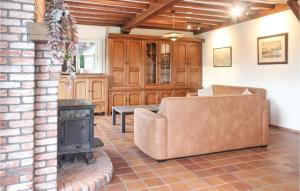 a living room with a couch and a stove at 4 Bedroom Gorgeous Home In Groede in Groede