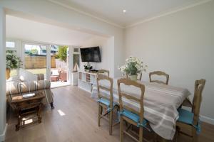 a bedroom with a bed and a living room at Meadow Drive in Bembridge