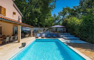 a swimming pool with lounge chairs and a house at Villa Tila in Pazin