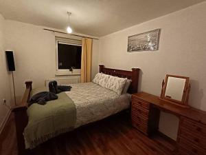 a bedroom with a bed and a dresser and a window at Sheffield Serenity in Heeley