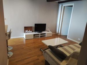 a living room with a couch and a tv at Casa Tabata fronte mare in Genoa