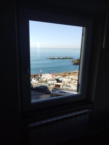 a window with a view of a beach at Casa Tabata fronte mare in Genoa