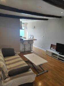 a living room with a couch and a table at Casa Tabata fronte mare in Genoa