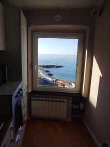 a window in a room with a view of the ocean at Casa Tabata fronte mare in Genoa