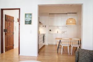 a kitchen and dining room with a table and chairs at FLH Estrela Comfortable Flat in Lisbon