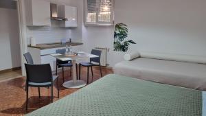 a small room with a bed and a table and chairs at BAM BAM TIBURTINA Guesthouse in Rome