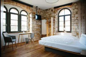 Postel nebo postele na pokoji v ubytování OX Hotel Altes Spital