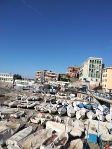 a bunch of boats are lined up in a harbor at Casa Tabata fronte mare in Genoa