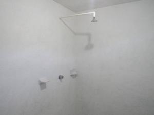 a white room with three shelves on a wall at surf la bamba in Dolores Miramar