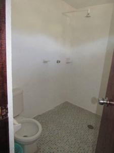a bathroom with a white toilet in a room at surf la bamba in Dolores Miramar +9 photos