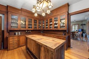 a large kitchen with wooden cabinets and a large wooden island at The Mulburn Inn in Bethlehem