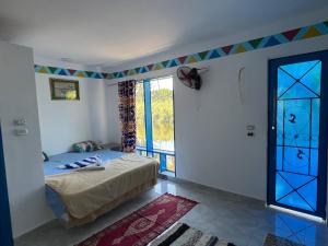 a bedroom with a bed and a window at Luxor Old Nile Hotel in Luxor