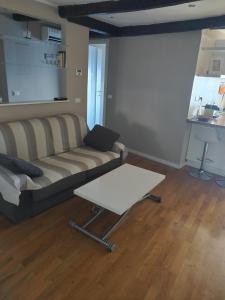 a living room with a couch and a coffee table at Casa Tabata fronte mare in Genoa