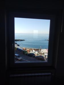 a window in a room with a view of the ocean at Casa Tabata fronte mare in Genoa