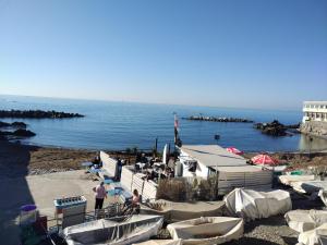 a group of boats on a beach near the water at Casa Tabata fronte mare in Genoa