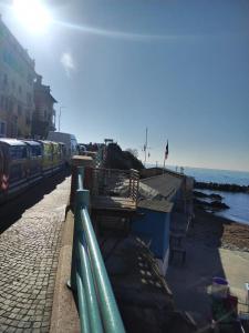 a train on a track next to the ocean at Casa Tabata fronte mare in Genoa