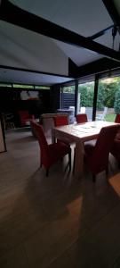 a dining room with a table and chairs and windows at Bungalow het Zuiderveld in Geesbrug