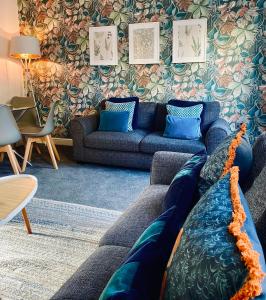 a living room with a blue couch and a table at Ambler Thorn Lodge in Queensbury
