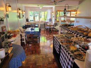 a buffet line with many different types of food at Pousada Betânia in Gramado