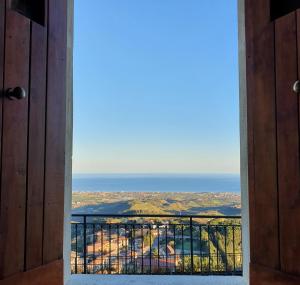 an open door with a view of the ocean at Albergo Palazzo Sant'Anna in Gerace