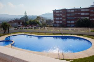 une grande piscine au milieu d'une ville dans l'établissement Precioso piso con vistas a las Islas Cíes, à Baiona