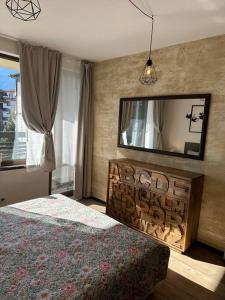 a bedroom with a bed and a large mirror at Top location unique apartment in Bansko