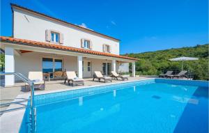 a villa with a swimming pool and a house at Awesome Home In Labin With Wifi in Labin +34 photos