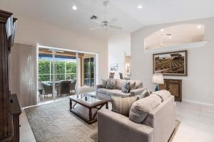 a living room with two couches and a table at Marco Home - 3BR - Pet Friendly - Pool & Lanai in Marco Island