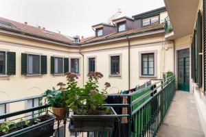 a balcony of a building with potted plants at Volta Accomodation in Milan