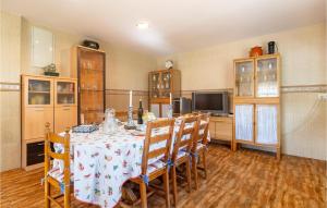 a dining room with a table with chairs and a television at Lovely Home In Chiclana De La Fronter in Chiclana de la Frontera