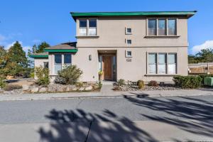 a house on a street with a tree at Beautiful Sunsets at 3BR Villa in Reno in Reno