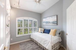 a bedroom with a bed and two windows at 316 Marco in Marco Island +41 photos