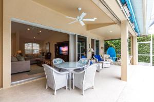 a dining room and living room with a table and chairs at Marco Home - 3BR - Pet Friendly - Pool & Lanai in Marco Island