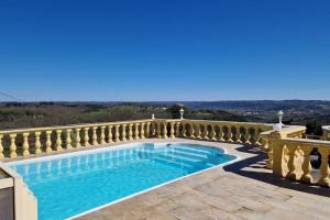 a swimming pool on a balcony of a house at Gites Domaine de Sweendy in Le Bugue