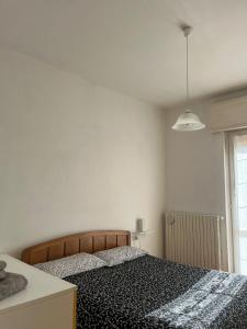 a bedroom with a bed and a white wall at Casa Castel in Civate