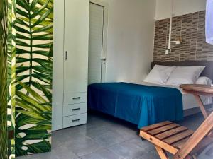 a bedroom with a bed and a wooden table at Au pied de la Soufrière in Saint-Claude